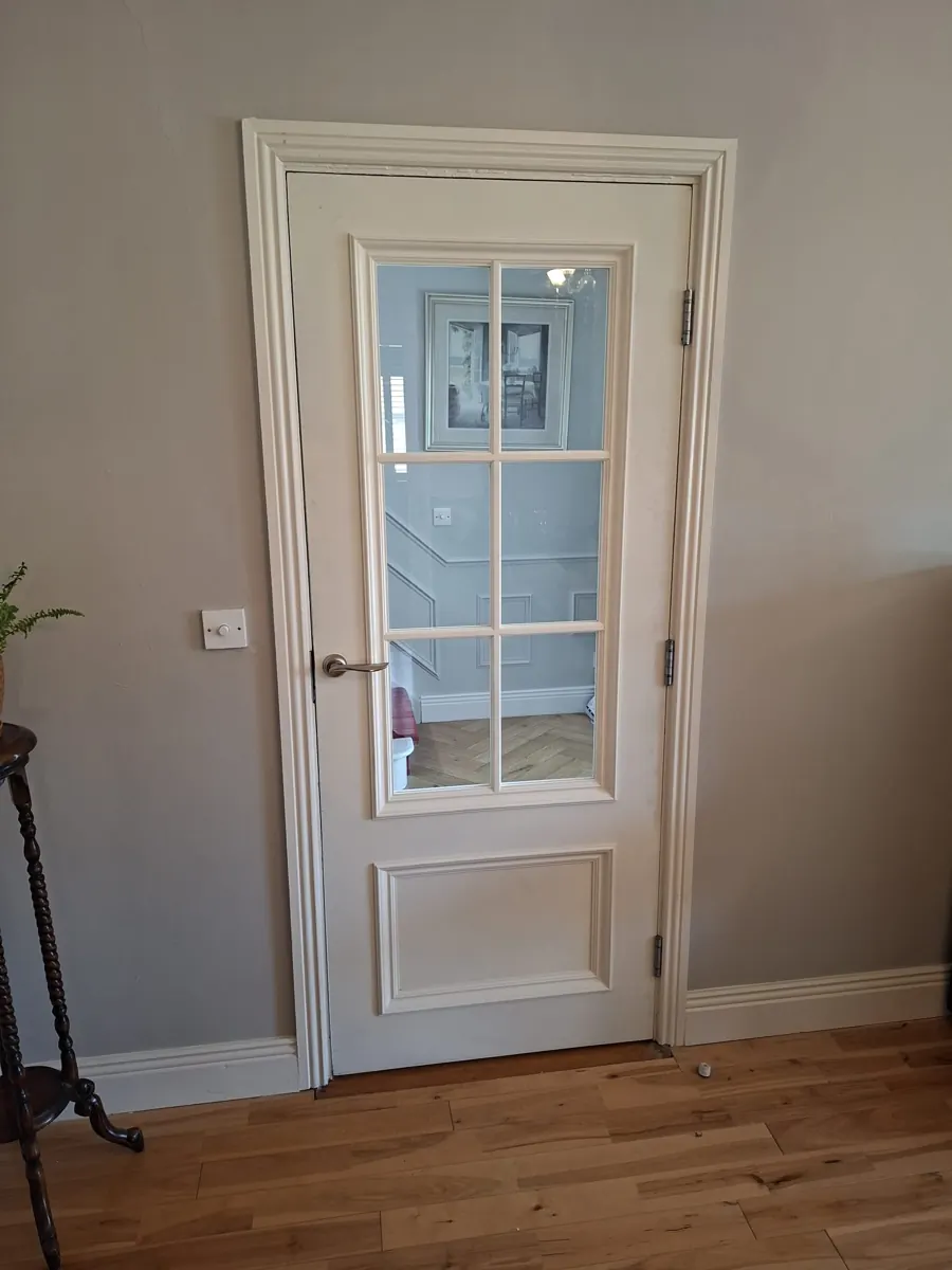 Glazed interior door with decorative moulding and fitted architrave completed by Stephen Ryan Carpentry Ltd.