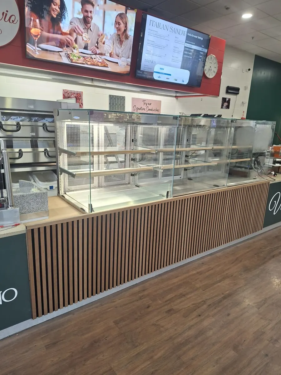 Commercial counter with slatted timber front completed by Stephen Ryan Carpentry Ltd.
