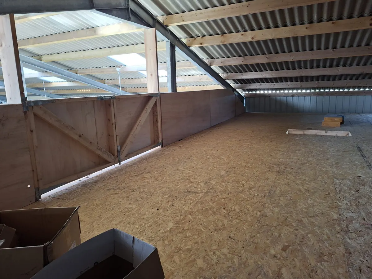 Timber roof structure and fitted attic flooring in a roof space.