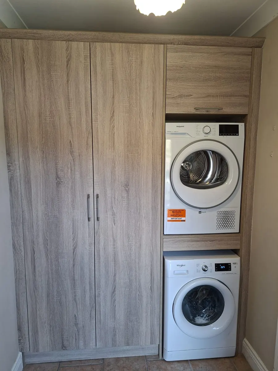 Tall laundry appliance housing and storage built around a washer and dryer.