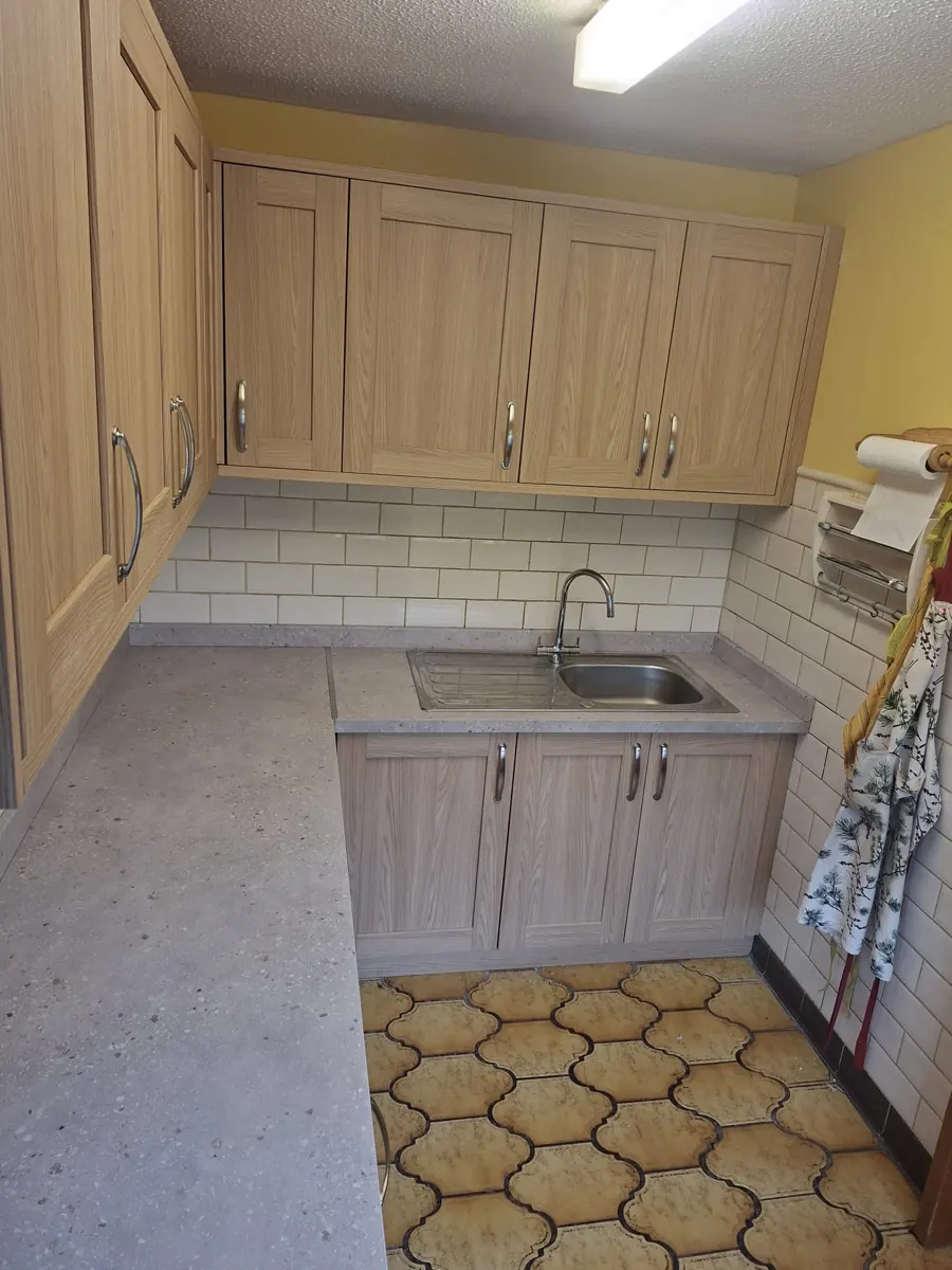 Fitted utility cabinetry with storage around a sink area.