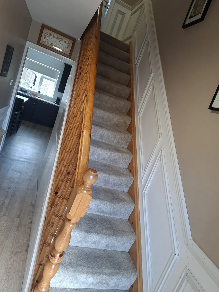 Decorative wall panelling fitted beside an interior staircase.